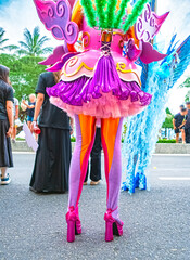 Crop photo of a woman in a bright costume at a street costume parade. Back view. Visible details:...