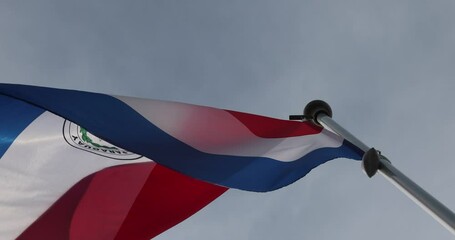 The National Flag of Paraguay flutters in the wind. Great for news. Close-up. The flag of Paraguay against the blue sky. 4K video.