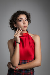 Vertical photo of curly-haired girl in red dress posing