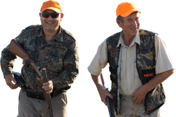 Silhouette of a hunter with a gun in the reeds against the sun, an ambush for ducks with dogs