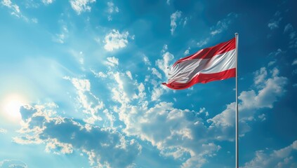 Austrian flag on a blue sky background. The waving national banner of Austria. A realistic photo with copy space concept for web design