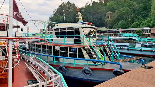 Local charter boats for inter-island crossings on Lake Toba carrying tourists, passengers and cargo. The ship travels from Parapat to the island of Samosir.