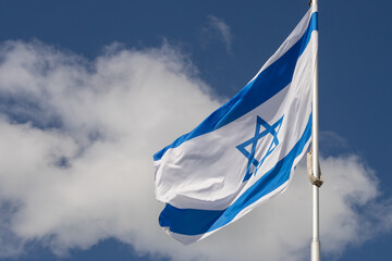 Large Israel flag waving in the wind. Israeli flag for advertising, holidays, achievements, festivals, elections. The Israeli flag flutters in the beautiful sky. Great for news.
