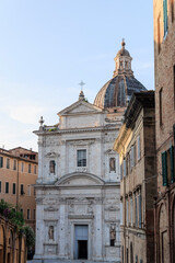 Fototapeta premium White Baroque syle Church on a Historic Street in a European Old Town, Siena, Tuscany, Italy