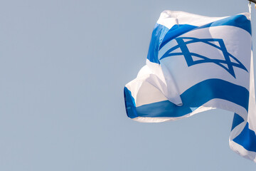Large Israel flag waving in the wind. Israeli flag for advertising, holidays, achievements, festivals, elections. The Israeli flag flutters in the beautiful sky. Great for news.