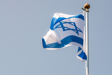 Large Israel flag waving in the wind. Israeli flag for advertising, holidays, achievements, festivals, elections. The Israeli flag flutters in the beautiful sky. Great for news.