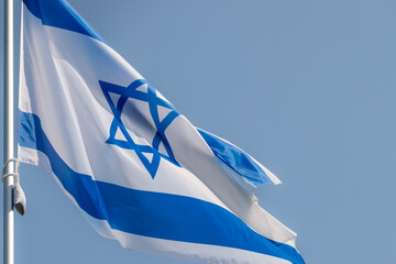 Large Israel flag waving in the wind. Israeli flag for advertising, holidays, achievements, festivals, elections. The Israeli flag flutters in the beautiful sky. Great for news.