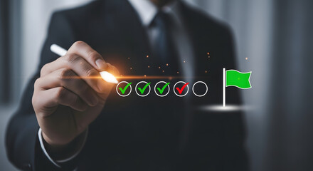 Businessman holding pen with holographic checklist and green flag, symbolizing completed tasks and successful project milestones in office.