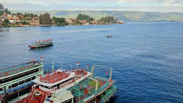 Local charter boats for inter-island crossings on Lake Toba carrying tourists, passengers and cargo. The ship travels from Parapat to the island of Samosir.