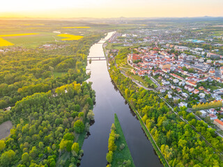 An aerial view captures the serene confluence of the Vltava and Labe rivers near Melnik. Lush...