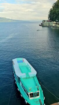 Local charter boats for inter-island crossings on Lake Toba carrying tourists, passengers and cargo. The ship travels from Parapat to the island of Samosir.