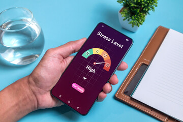 Man holding smartphone to use an app to measure his stress level