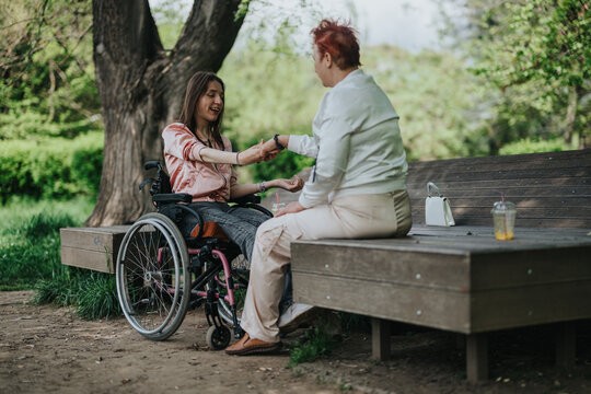 A compassionate scene featuring two women in an outdoor park. They engage positively on a bench, showcasing empathy and friendship while surrounded by trees and greenery.