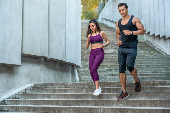 Healthy, couple or athletes in city running on stairs for exercise, workout or training for marathon. Sports, man and woman jogging in urban area active for wellness, cardio and endurance or strength