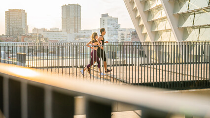 Couple, exercise and running for workout in city, cardio together with fitness and wellness. Below...