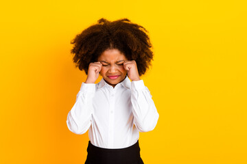 Young schoolgirl showing expression on yellow background conveying emotions of youth and childhood