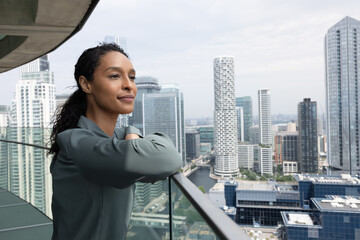 Professional woman with serene expression by skyline