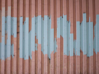 Peeling paint on corrugated metal surface