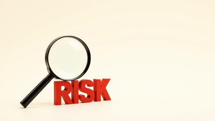 Analyzing Risk with a Magnifying Glass on the Word 'RISK'