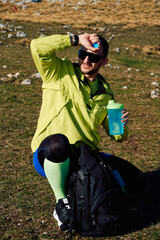 Thirsty Hiker Replenishes Energy with Water During a Well Earned Mountain Break.