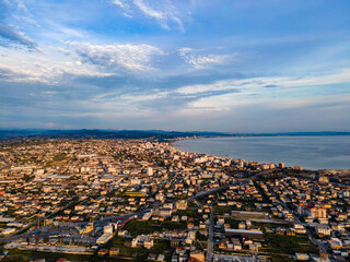 High-angle drone view of Durrës, Albania, captured during golden hour at sunset. 