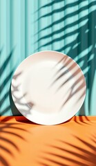 White plate on orange surface with palm leaf shadows against a teal curtain backdrop
