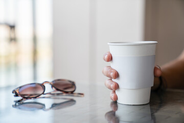 Close up woman hands holding disposable coffee cup mockup,