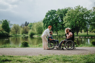 Four individuals, including two in wheelchairs, share a relaxed, supportive moment beside a serene...