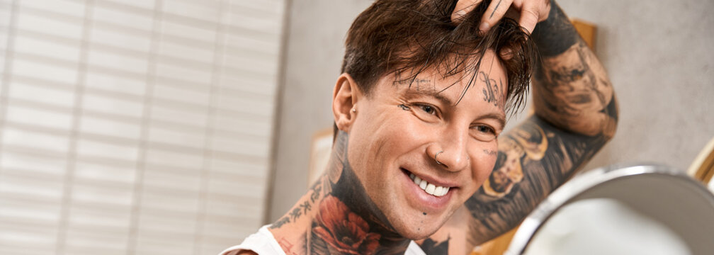 Stylish young man with tattoos enjoys a cozy moment at home in relaxed atmosphere - Powered by Adobe