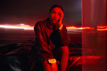 Young elegant woman showcases modern style in a vibrant atmospheric setting