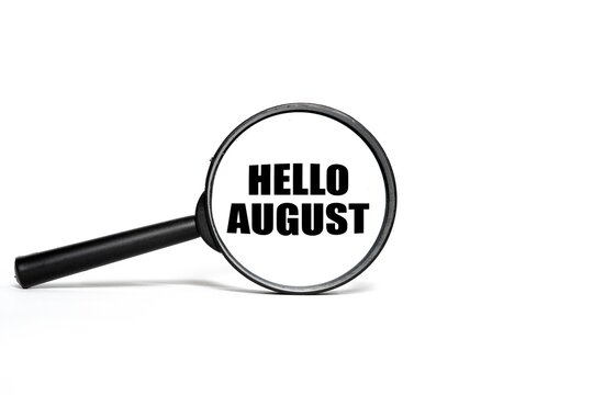 A magnifying lens highlighting the text "HELLO AUGUST" isolated on a white background.