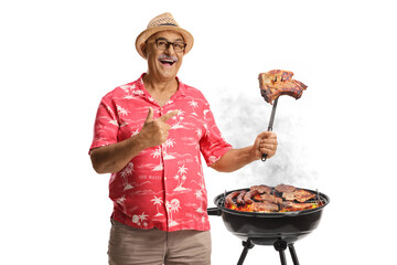 Happy mature man making a grilled barbecue steak