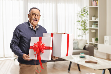 Happy mature man holding a gift box