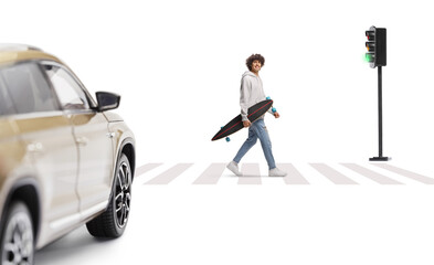 Guy carrying a longboard and walking at zebra crossing