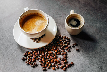 Espresso coffee cup with Americano coffee shot and roasted coffee beans on gray background