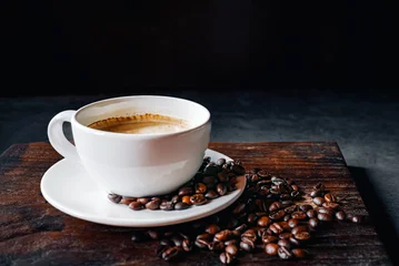  Coffee cup and coffee beans on gray background,  Espresso coffee cup aromatic on a wooden tray © NARONG