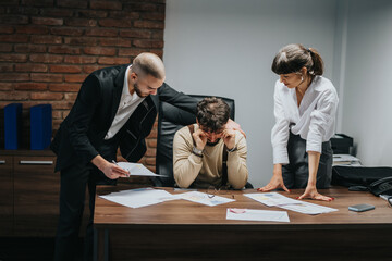 Three colleagues are engaged in an intense discussion during a meeting in a professional office...