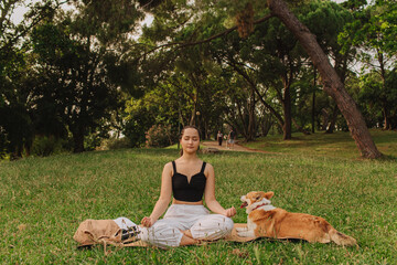 Fit sporty mindful young woman meditating, doing yoga and breathing exercises with eyes closed,...