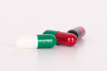 Colorful medicine capsules on white background