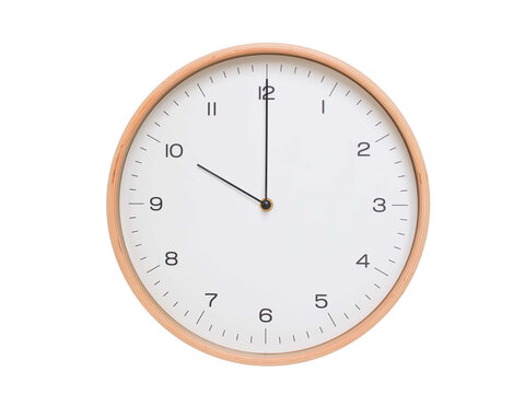 Minimal wall clock with light wood frame and white face displaying 10:00 or 22:00. Perfect for clean, modern concepts about time and scheduling.