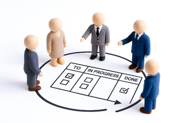 Wooden figurines representing team engaged in leadership concept with task management board, emphasizing agile collaboration and progress tracking in professional setting