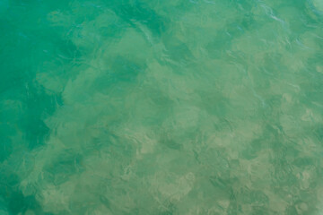 Abstract texture of a swimming pool water reflecting white light