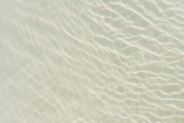 Abstract texture of a swimming pool water reflecting white light