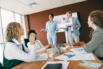 Professional colleagues engaging in a brainstorming session in a modern office environment