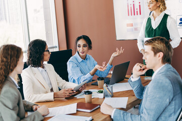 Professional business team collaborating on a company project in a modern office environment with motivated discussions