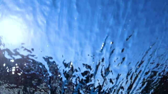 Background and texture of moving transparent water on blue sky.
