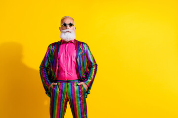 Photo of serious brutal senior man wear trendy striped bright suit hand hold in pockets isolated on...