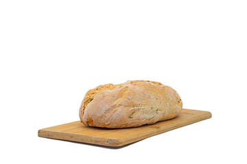 A whole loaf of baked homemade bread lies on a wooden cutting board made of bamboo wood, isolated...