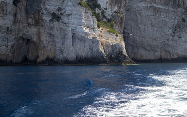 dramatic sea cliffs, deep blue water, mediterranean coastline, rugged landscape, ocean waves