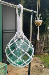 Extra large green glass Japanese fishing float wrapped in macrame and hung up